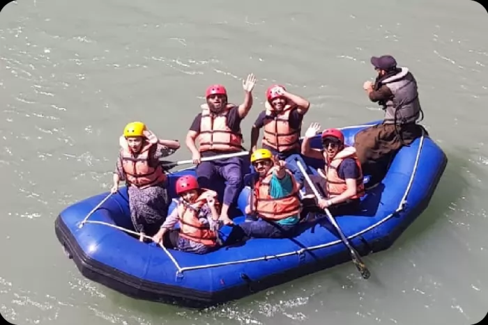 The team white-water rafting together