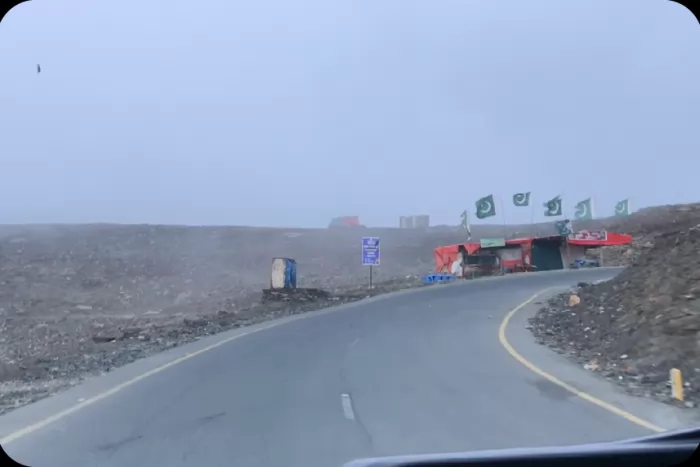 The road up to a flag-lined mountain pass
