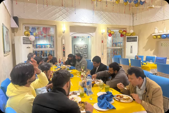 A decorated table and the team sharing a meal