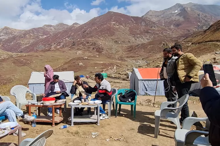 The team at a mountain campsite on a company trip