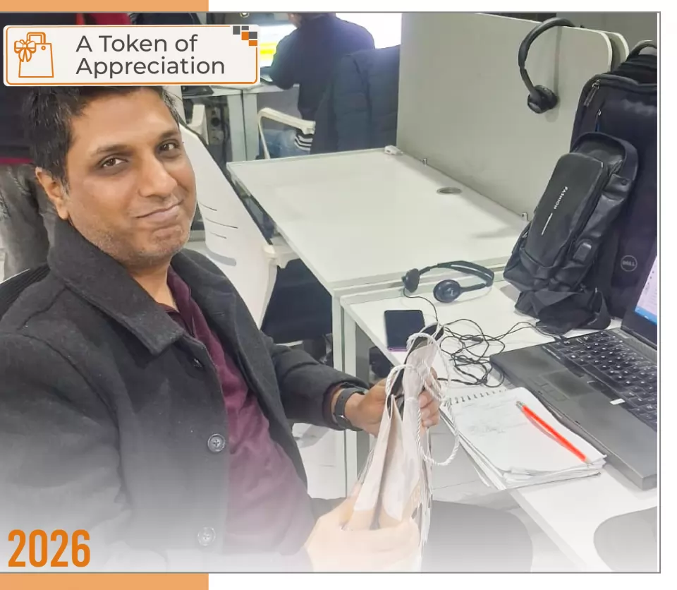 2026 — A Token of Appreciation: a team member recognised at their desk.